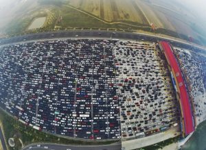 Vehicles are seen stuck in a traffic jam near a toll station as people return home at the end of a week-long national day holiday, in Beijing, China, October 6, 2015. Picture taken October 6, 2015. REUTERS/China Daily CHINA OUT. NO COMMERCIAL OR EDITORIAL SALES IN CHINA - RTS3HL5