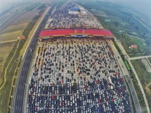 Vehicles are seen stuck in a traffic jam near a toll station as people return home at the end of a week-long national day holiday, in Beijing, China, October 6, 2015. Picture taken October 6, 2015. REUTERS/China Daily CHINA OUT. NO COMMERCIAL OR EDITORIAL SALES IN CHINA - RTS3HL3